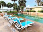 Relax on the lounge chairs by the swimming pool